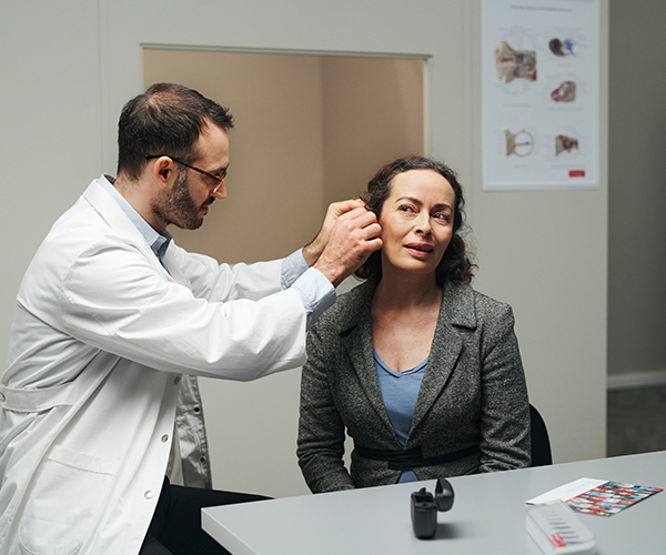 Audiologist fitting client CIC